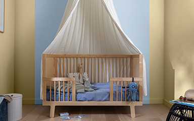 Child’s room with cot and striped wall