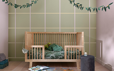 Kid’s bedroom with a green checkerboard feature wall and light purple opposing walls