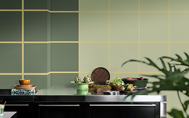 Kitchen with two tonal green walls and a checkerboard pattern