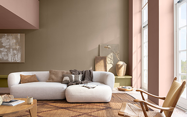 Living room with muted brown pink pilars and brown wall and white sofa